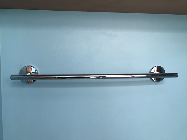 An aqua wall with a chrome towel bar from Another RV Renovations Update