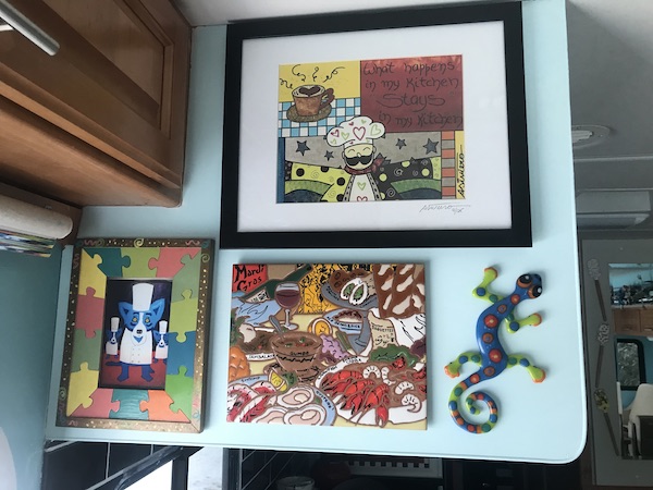 An aqua wall with artwork hanging from Another RV Renovations Update