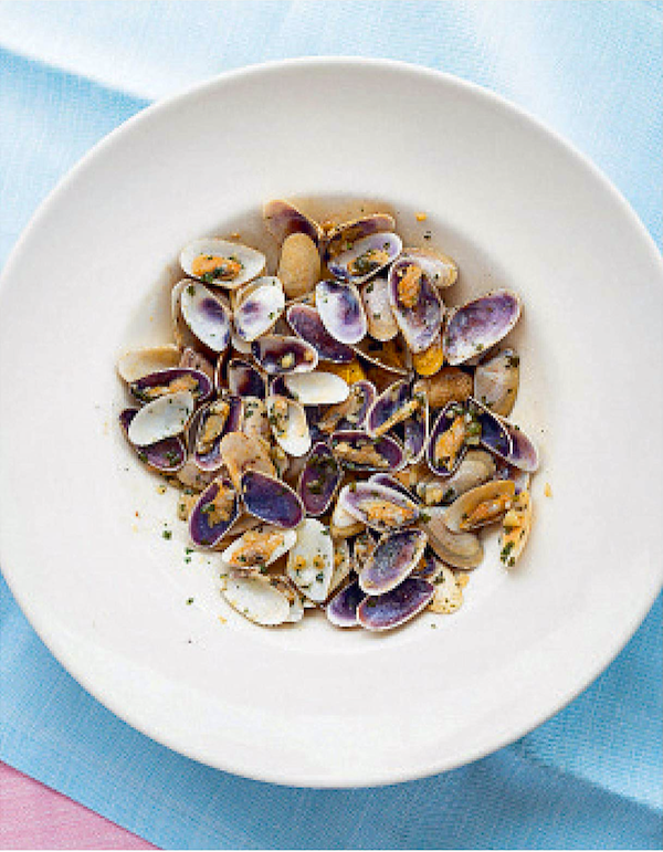 A white bowl filled with fried cockles in their shells from Barcelona Cult Recipes