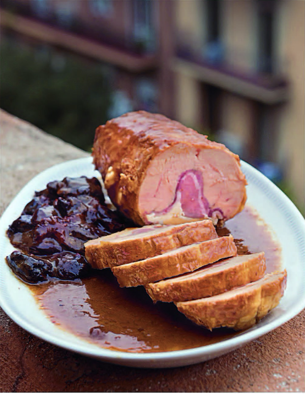 Slices of stuffed roast chicken with sauce on a white plate from Barcelona Cult Recipes