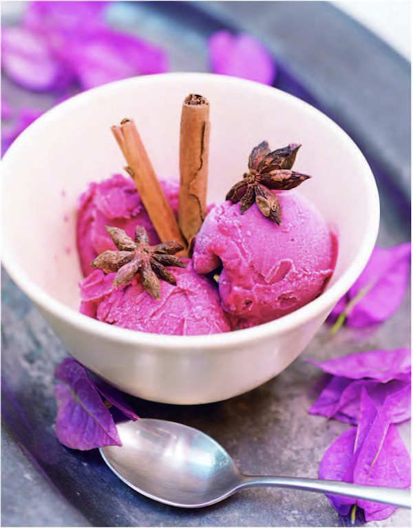 A deep white bowl filled with 3 vibrant magenta scoops of sorbet from Barcelona Cult Recipes