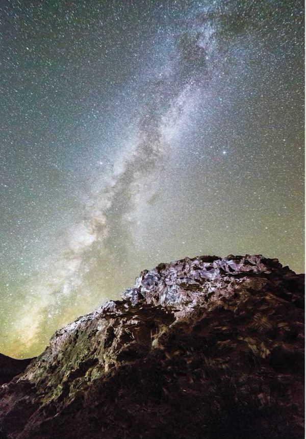 A mountain in the foreground with galaxy stars from Complete Guide to the National Parks