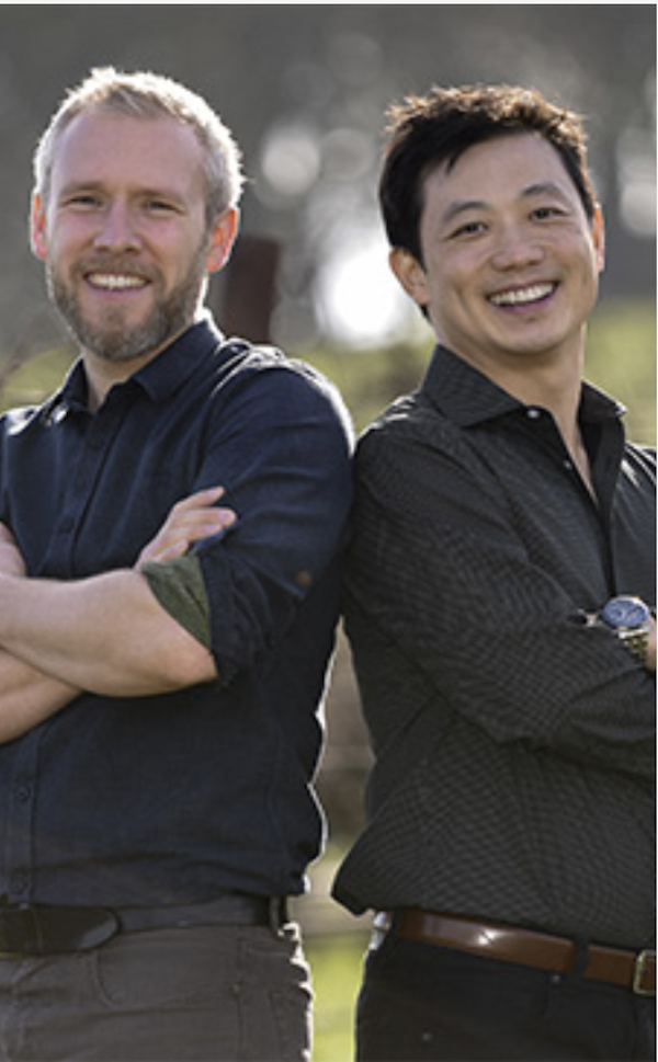Two men in black shirts standing shoulder to shoulder from post on First Burgundy Truffle Harvest in America