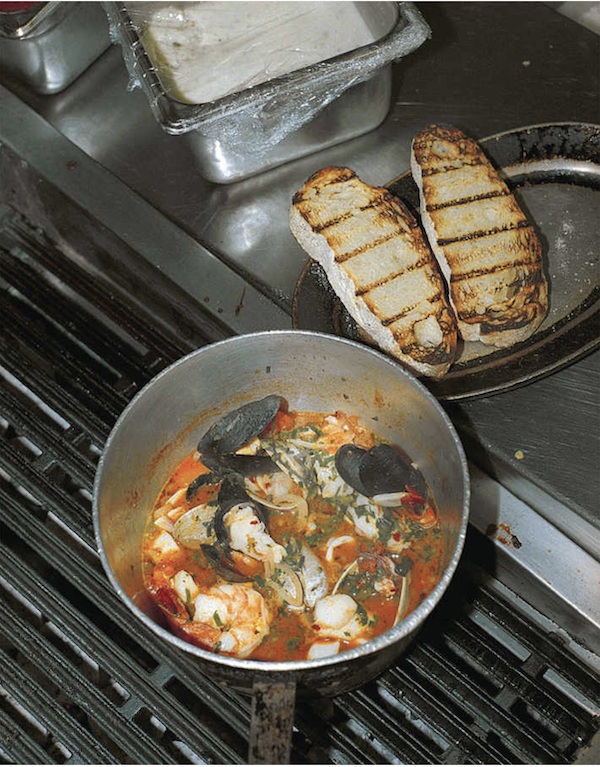 A bowl of fish stew and two slices of grilled bread from Los Angeles Cult Recipes