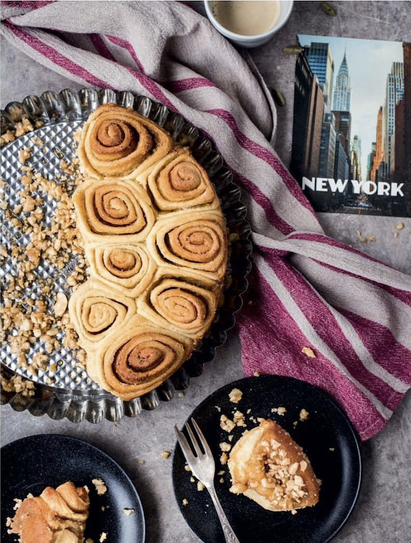 A round baking pan filled with cashew caramel rolls from New York Capital of Food