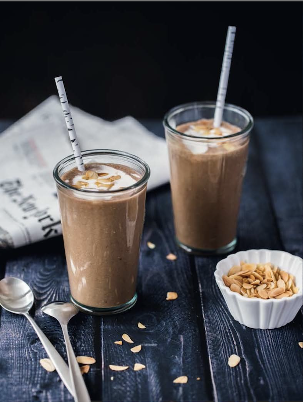A pair of glasses with straws filled with coffee smoothies from New York Capital of Food