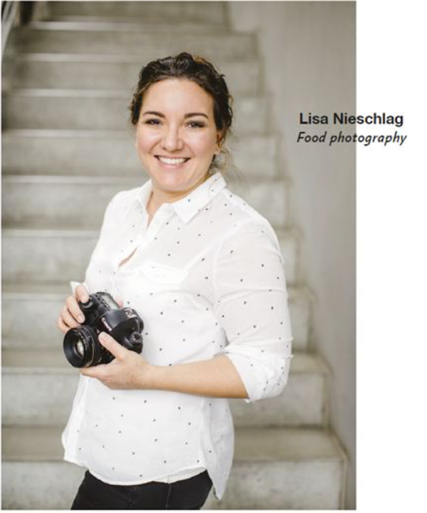 A woman holding a camera from New York Capital of Food