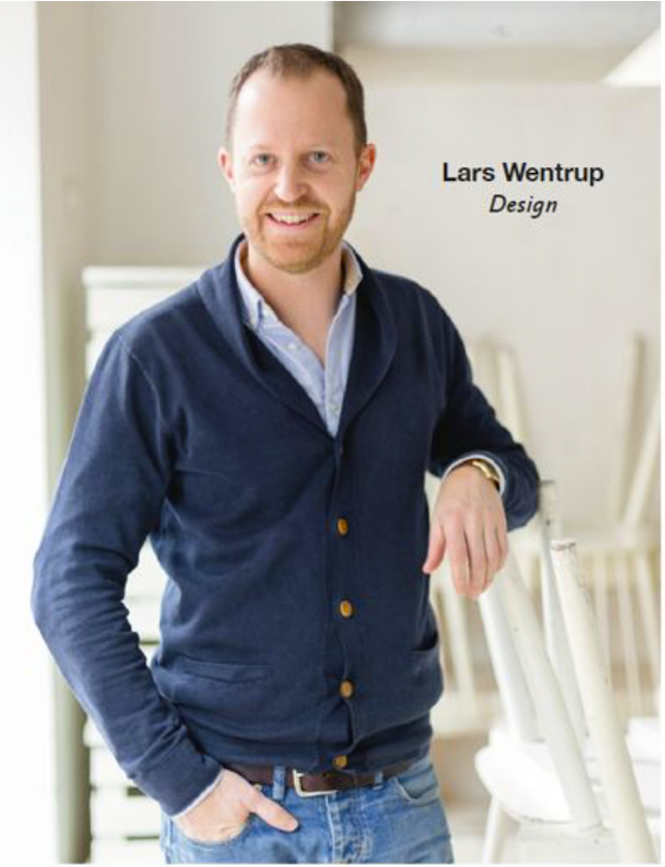 A man in a navy V-neck sweater from New York Capital of Food