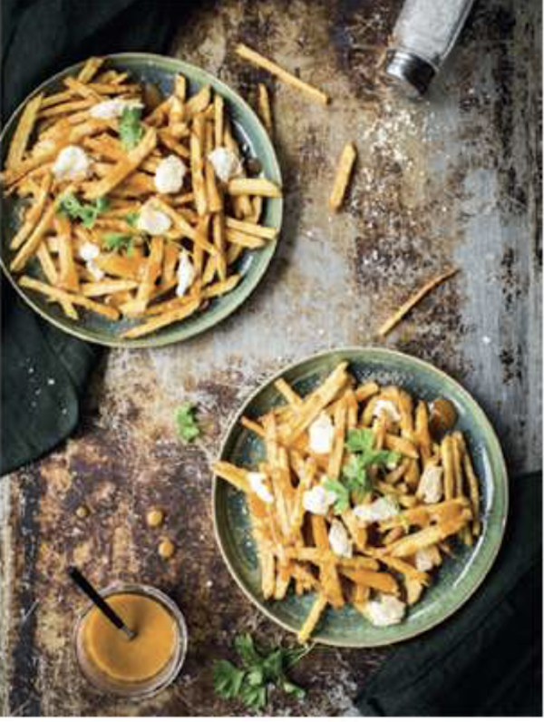 Two sage green bowls filled with fries, gravy and cheese curds from Taste the Wild