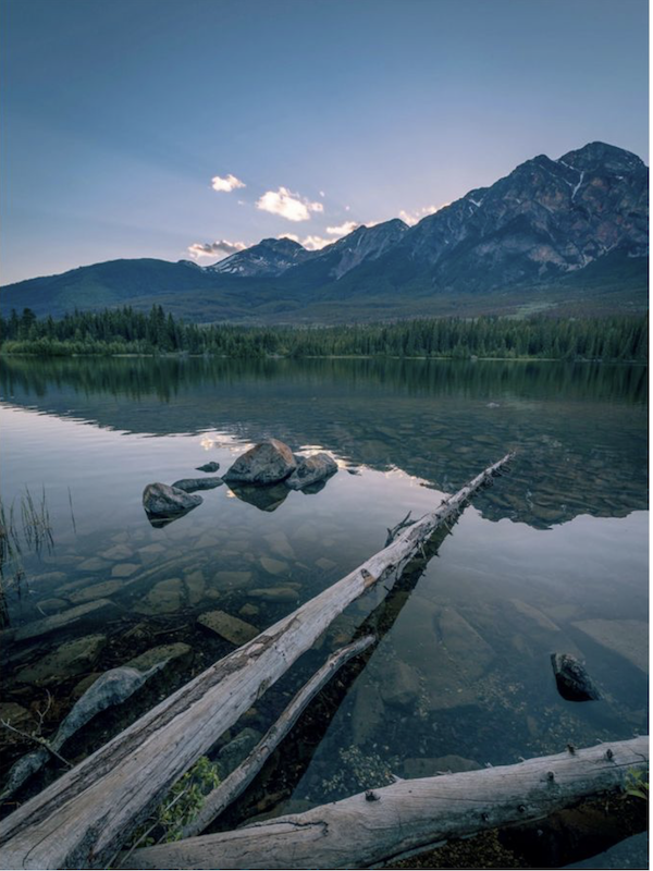 A calm lake with mountains in the background from Taste the Wild