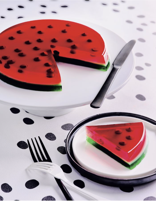 A white platter topped a round watermelon jelly and a white plate topped with a wedge of the jelly from Bake Australia Great