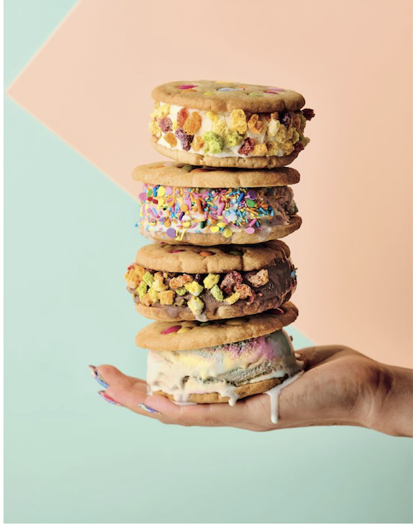 A hand holding a stack of ice cream sandwiches from Bake Australia Great
