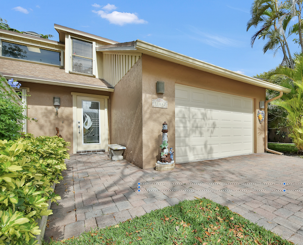The front of a house with paver driveway from Ready to Live Our Dream