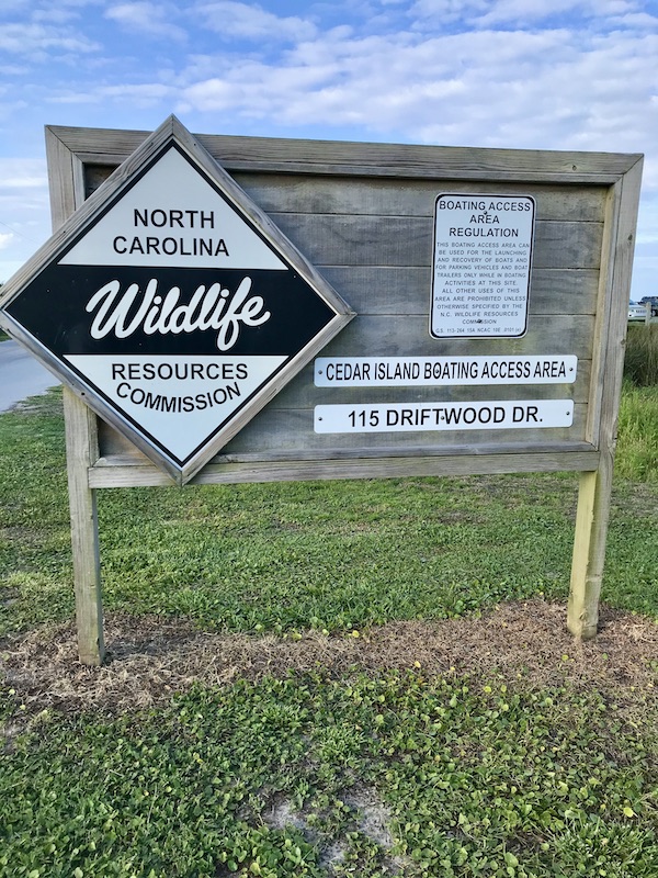 A sign for wildlife on grass at Cedar Island Resort in NC