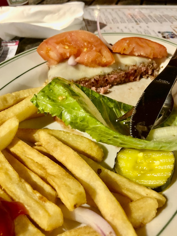 A platter with half of a burger, lettuce, tomato, pickles and fries at Little Duck Diner, Savannah