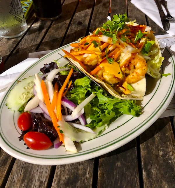 An oval platter with two shrimp tacos and salad at Little Duck Diner, Savannah