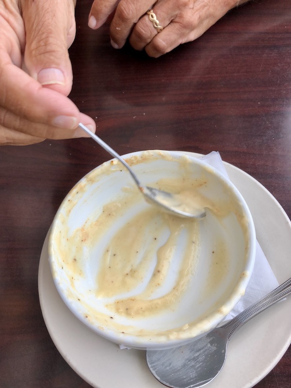 Scraping the last drop of creamy soup from a bowl in Chesapeake Virginia
