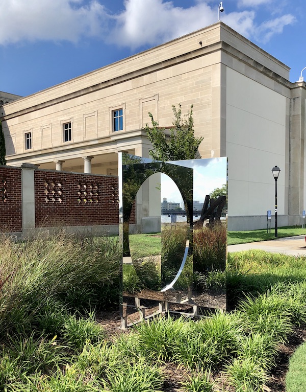 A reflective mirror sculpture in a garden in Chesapeake Virginia
