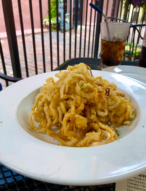 A large white bowl filled with a mound of fried onion straws at Hoppin' Johnz in Elizabeth City NC
