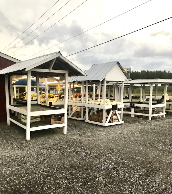 White roofed farm stands with produce near North River Campground NC
