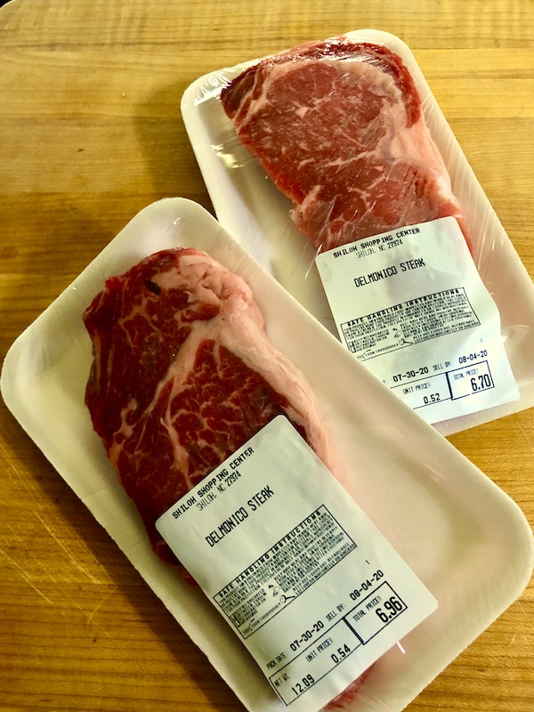Two packages of steak sitting on a cutting board at North River Campground NC