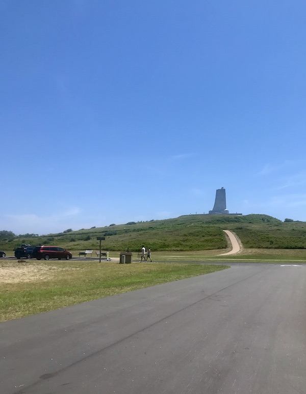 A monument atop a high hill with path leading up to it in OBX Outer Banks North Carolina