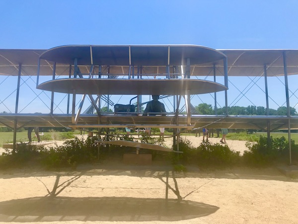 A metal sculpture of a bi-plane with pilot in OBX Outer Banks North Carolina