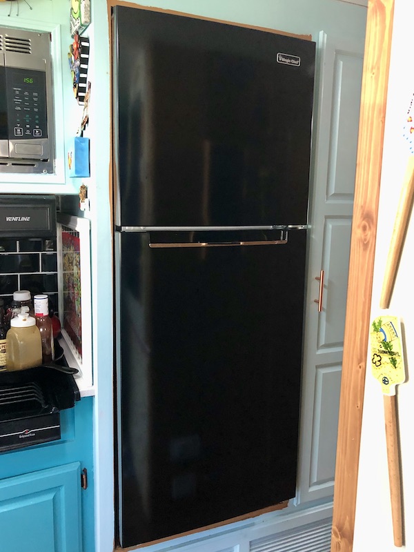 New black fridge in an RV from RV Renovations Complete The Big Reveal