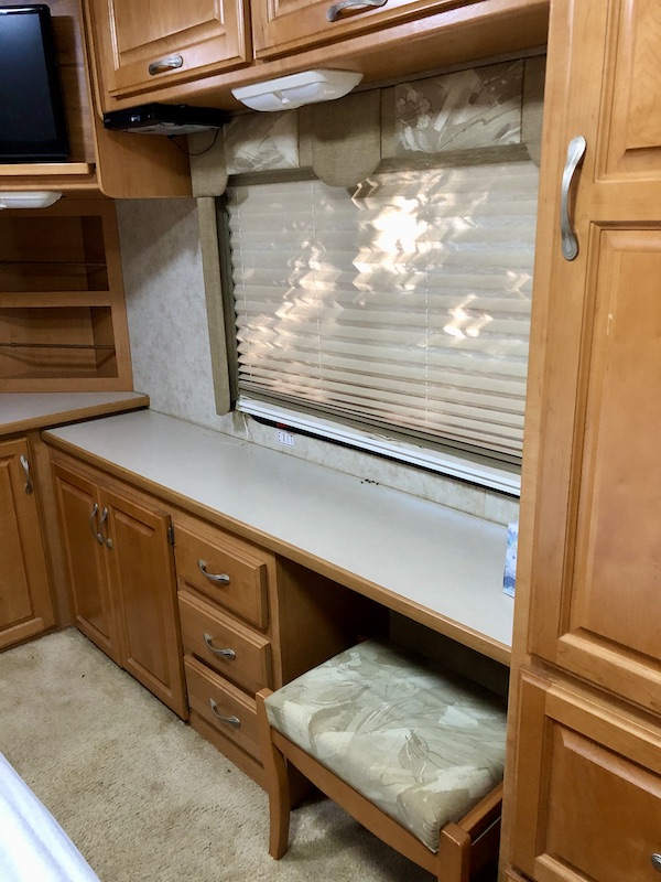 An RV bedroom counter and desk with window from RV Renovations Complete The Big Reveal