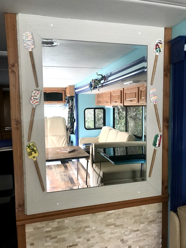 A spatula collection displayed around a mirror from RV Renovations Complete The Big Reveal