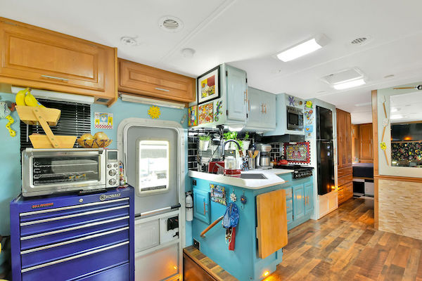 The entry area and kitchen of an RV from RV Renovations Complete The Big Reveal