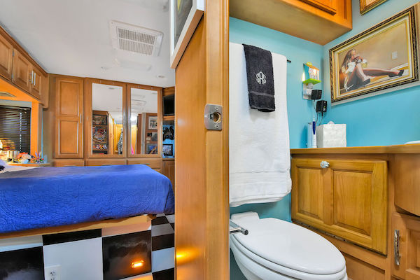 Looking into the bedroom and bathroom of an RV from RV Renovations Complete The Big Reveal