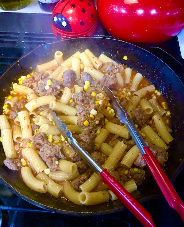 Pasta and sauce with sausage and corn in a cast iron pan for my Rigatoni with Green Cut Sausage