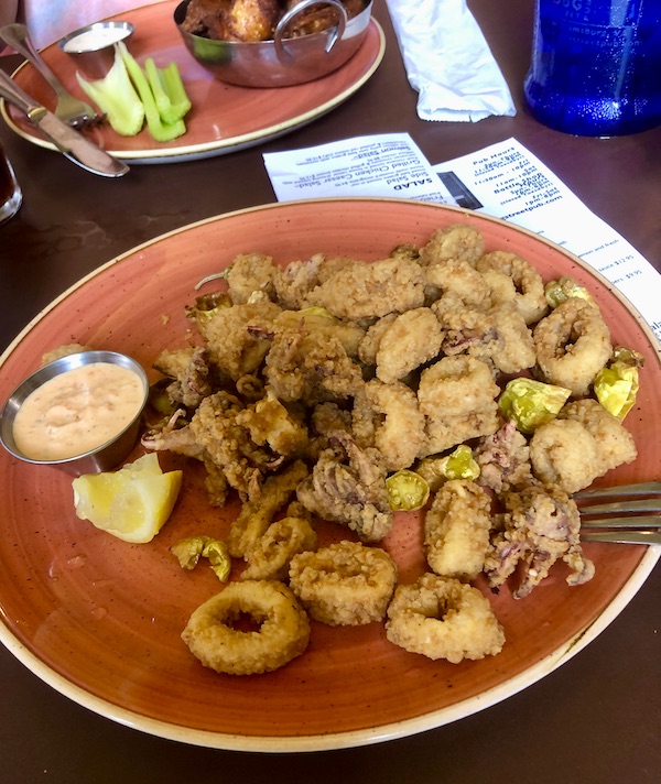 A rust colored platter topped with fried calamari in Williamsburg Virginia