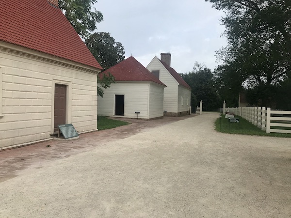A trio of off white houses with red roofs at George Washington's Mount Vernon