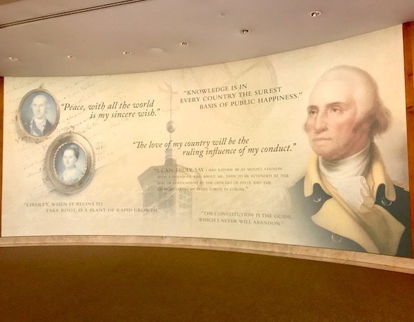 A curved wall with photos and information about George Washington's Mount Vernon