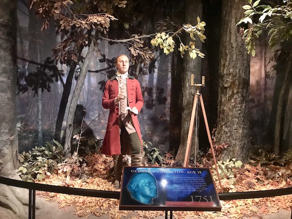 A wax figure of a young George Washington in a red coat at George Washington's Mount Vernon