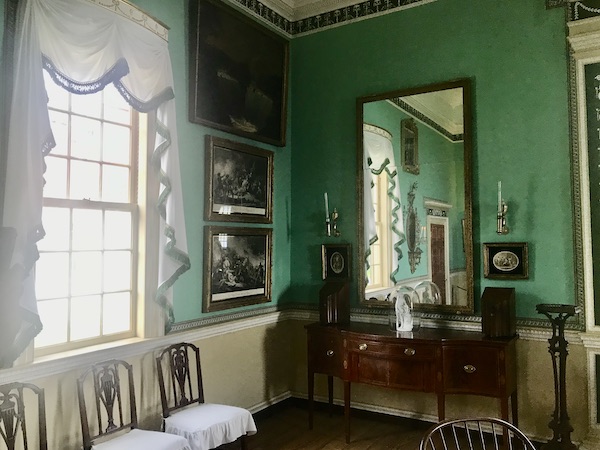 A large room with green walls, draped windows and mirrors at George Washington's Mount Vernon