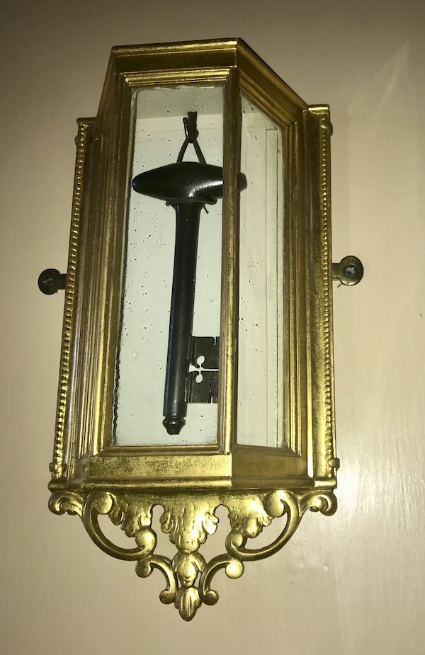 A gilded frame displaying a large key on the wall at George Washington's Mount Vernon