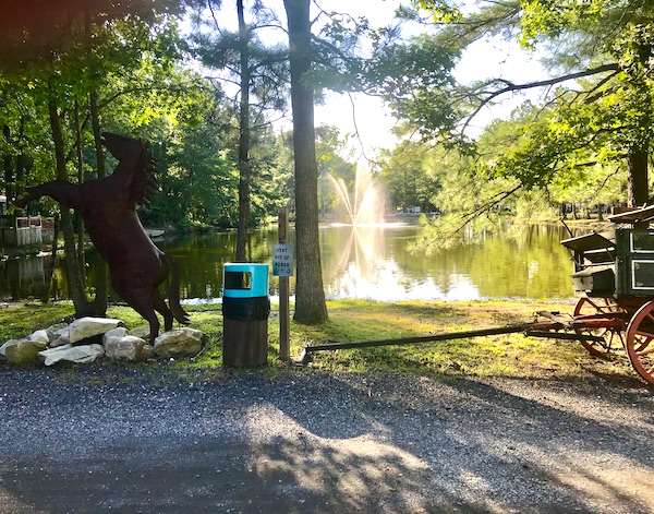 A horse sculpture by a lake with a fountain at Lake Somerset Campground