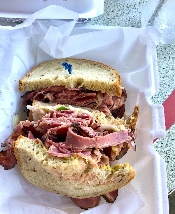 At Maryland and Virginia Beaches a pastrami sandwich in a white styrofoam take out clamshell