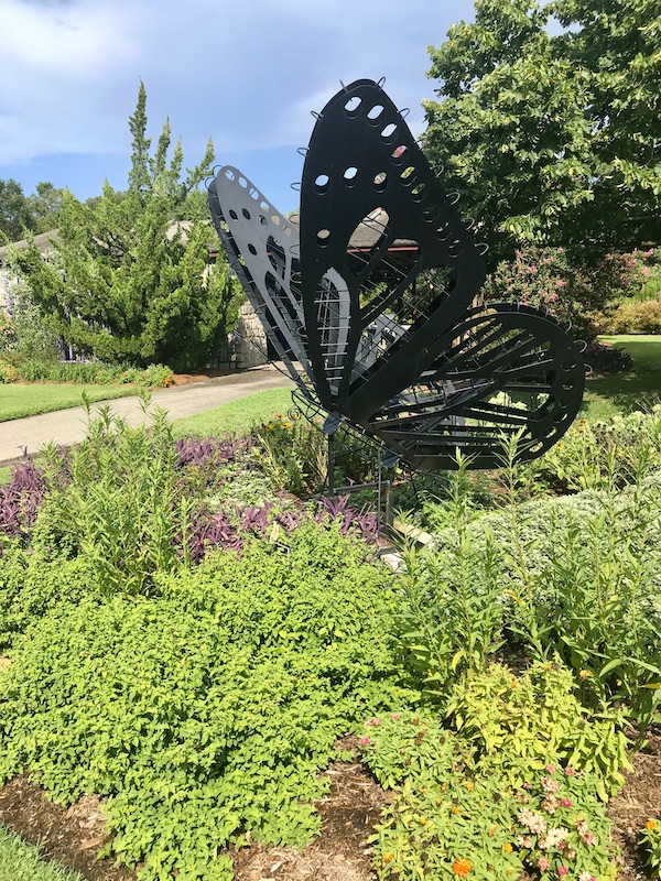 A large butterfly sculpture in the garden at the Norfolk Botanical Gardens