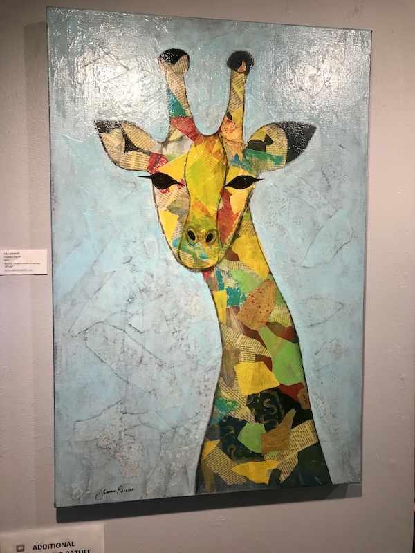 A painting of a giraffe in a patchwork of colored at The Torpedo Factory Alexandria Virginia