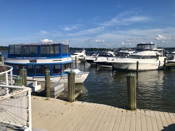 A marina with several sport fishing boats docked behind The Torpedo Factory Alexandria Virginia