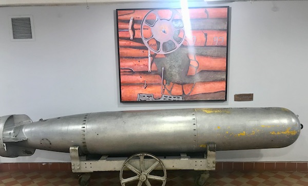A grey torpedo with and orange and gray painting above it at The Torpedo Factory Alexandria Virginia