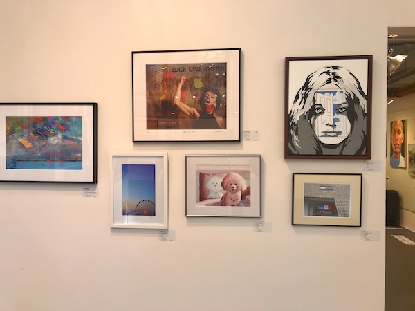 A flesh colored wall with art hanging on it at The Torpedo Factory Alexandria Virginia