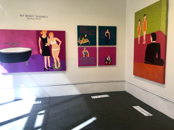 White gallery walls with colorful art hanging at The Torpedo Factory Alexandria Virginia