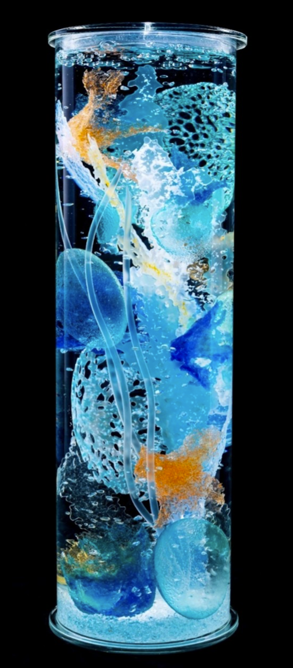 A glass cylinder filled with glass objects in aqua and cobalt at The Torpedo Factory Alexandria Virginia