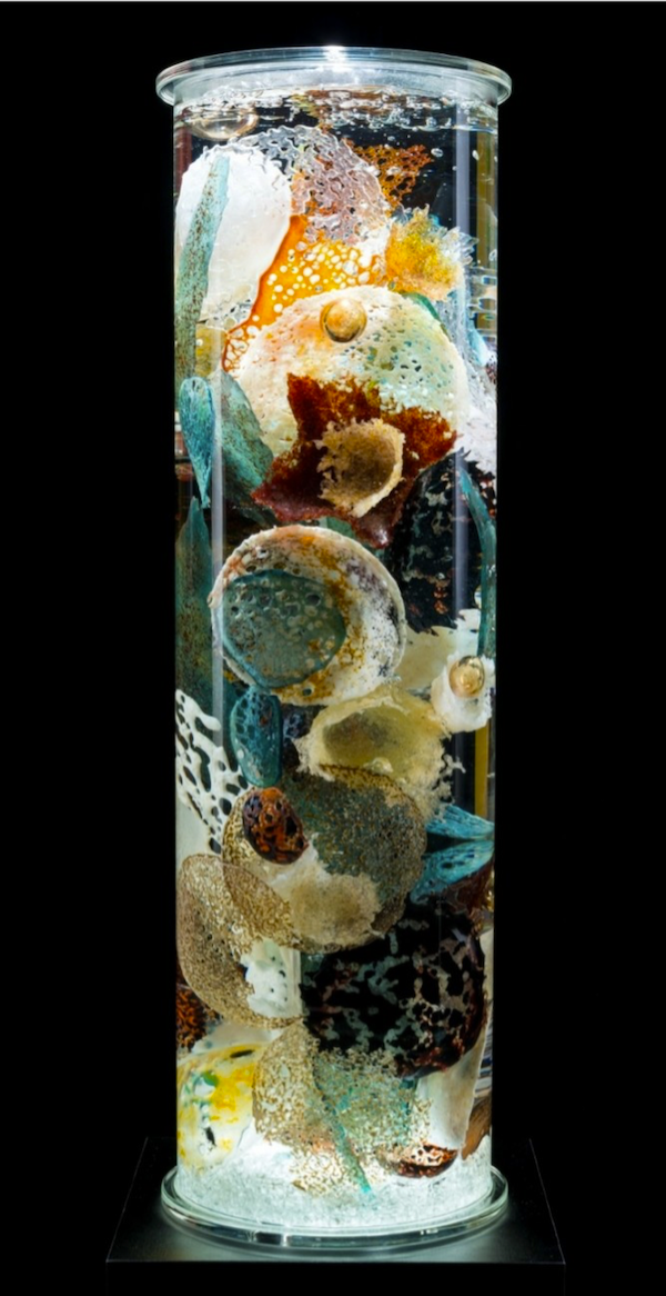 A glass cylinder filled with glass seashells in browns and aqua at The Torpedo Factory Alexandria Virginia