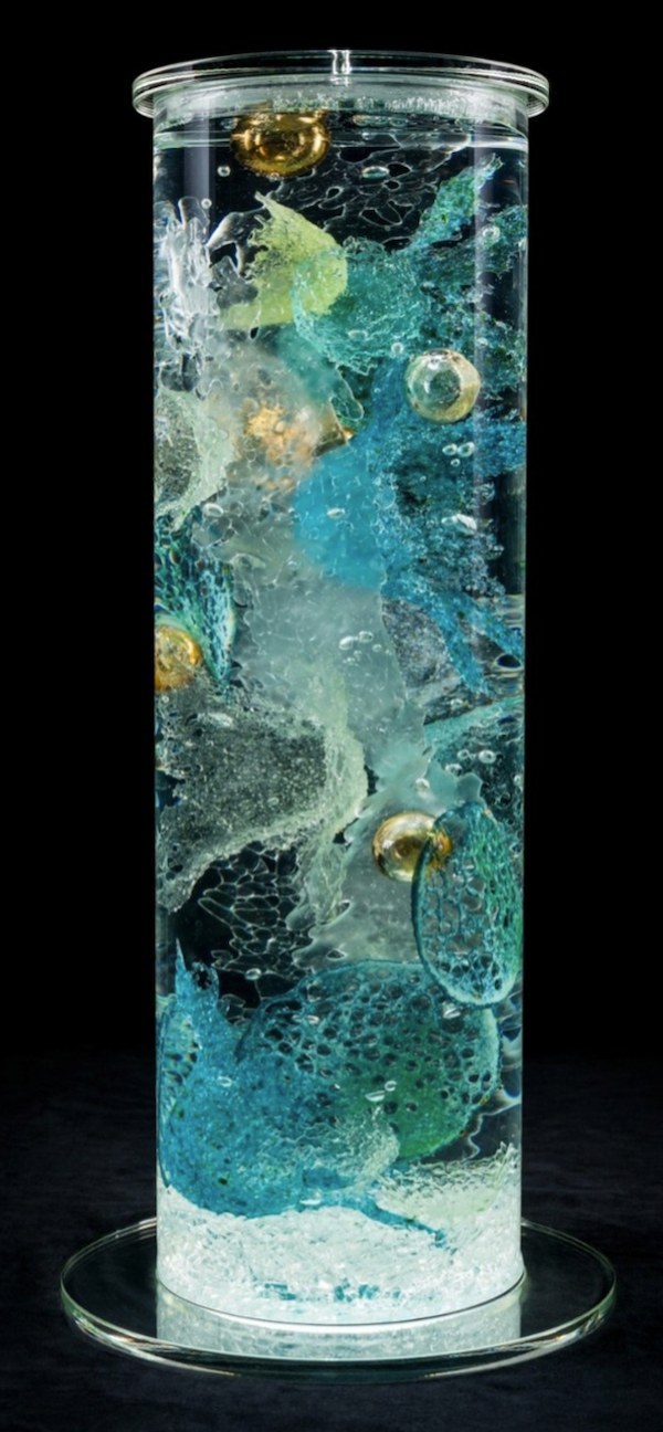 A glass cylinder filled with aqua object at The Torpedo Factory Alexandria Virginia